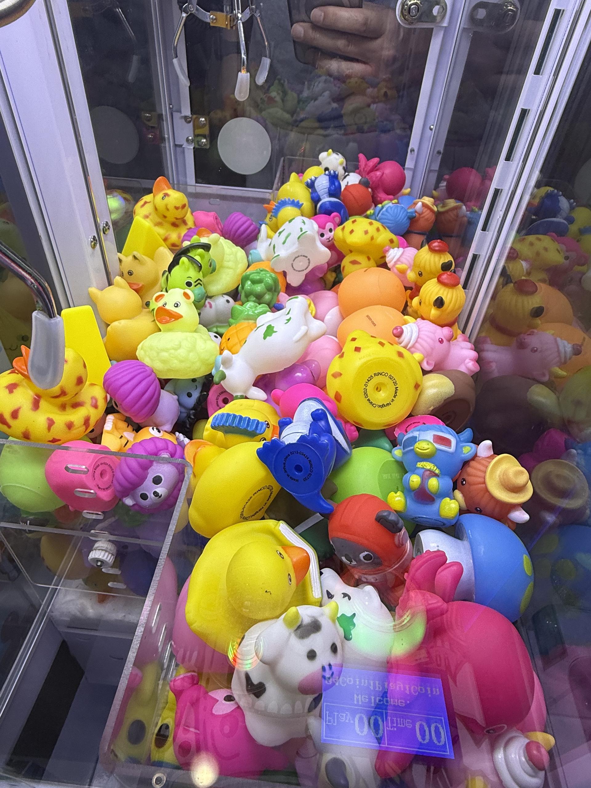 Mini claw machine at a laundromat-style family waiting area